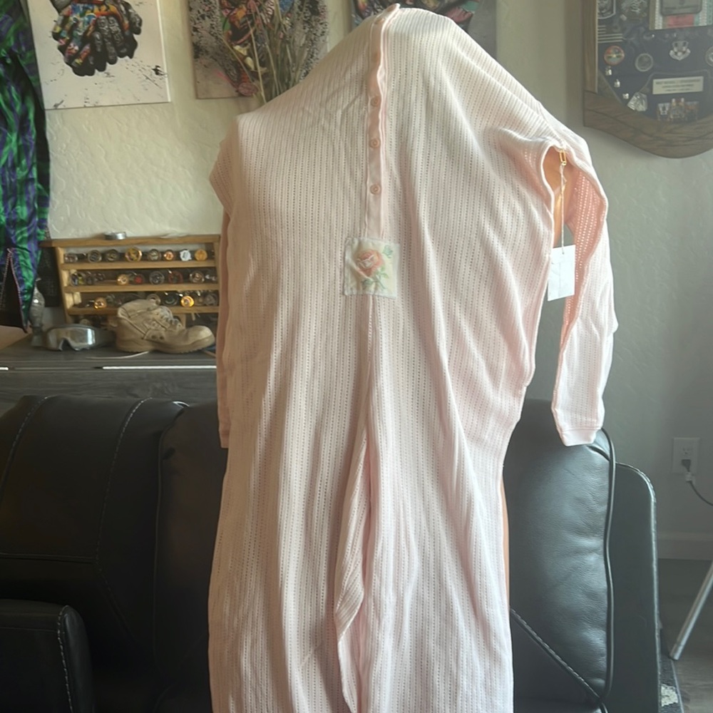 Very cute pajama one piece.  Brand new.  Has a little flower on front.  pink.